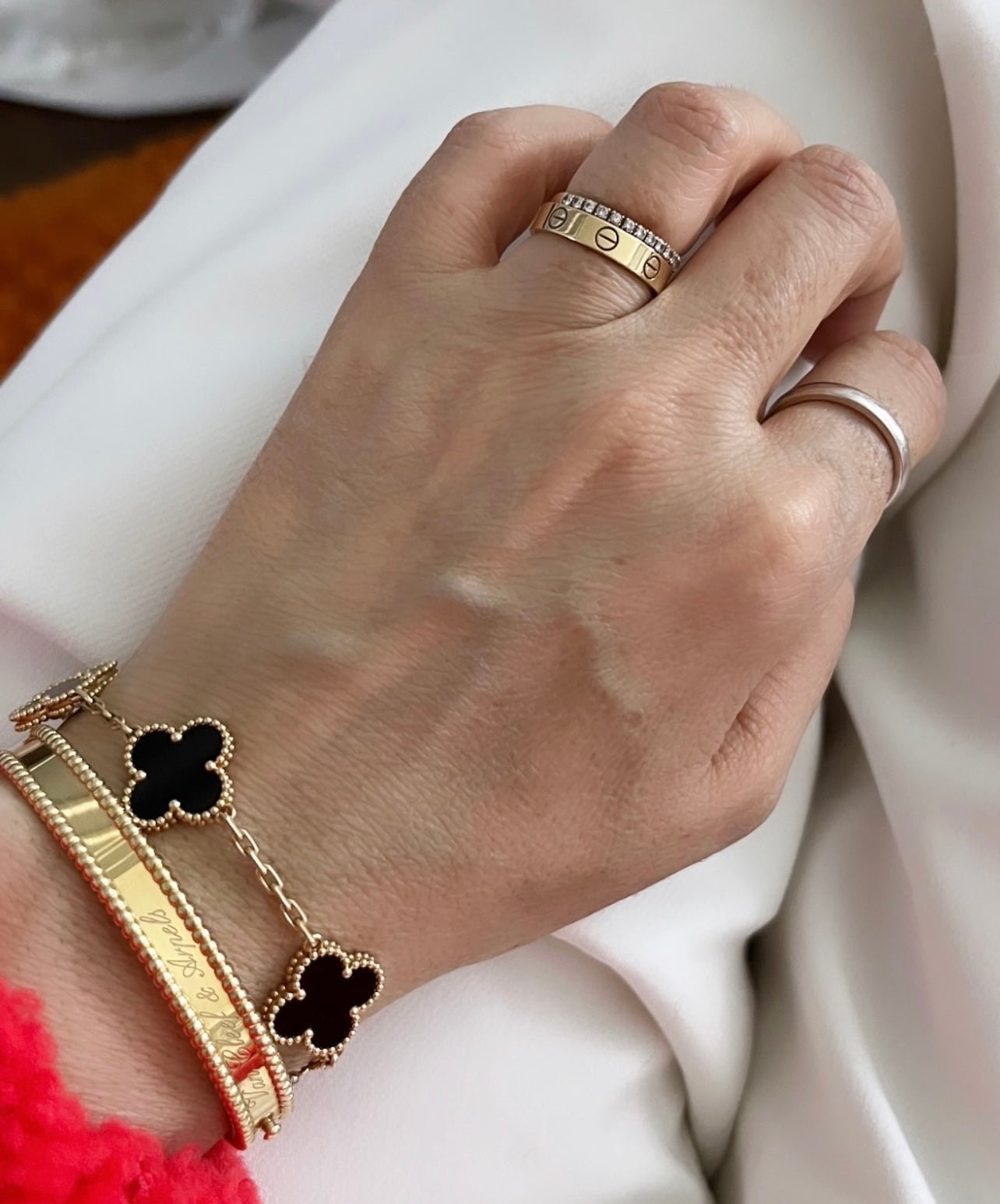 Genuine black Onyx stone inserts framed by 18k gold in a luxury clover charm bracelet.