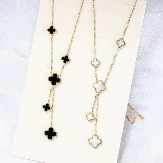 Elegant black onyx and 18k gold clover pendant on a delicate chain, a sophisticated minimalist luxury accessory for women.
