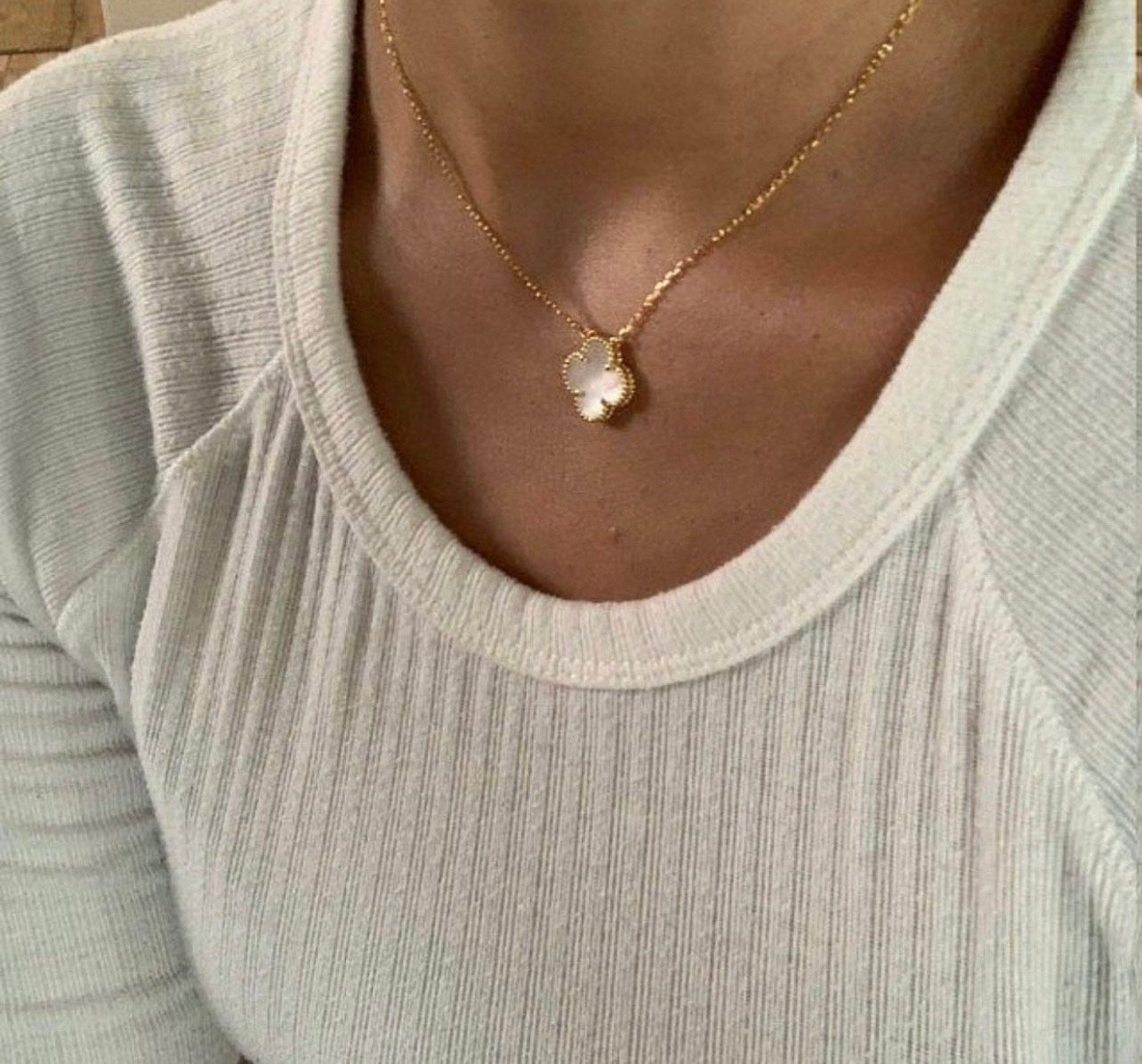 Elegant four-leaf Mother of Pearl pendant in a beaded 18k gold setting, a lucky charm designer-style necklace.